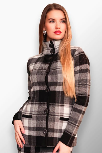 Woman wearing a black and white plaid short coat with a high neck buttoned design.