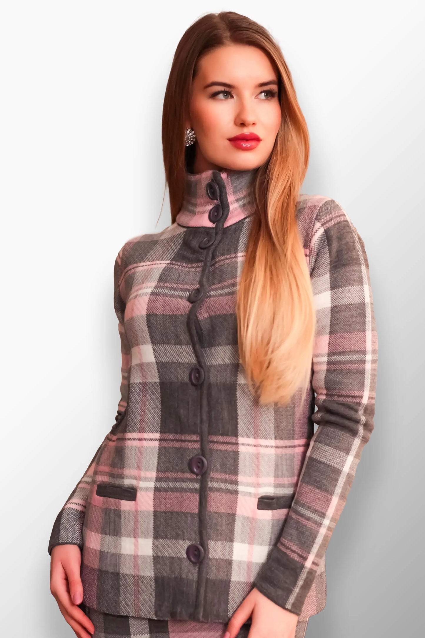 Woman in a soft gray and pink plaid short coat with a high buttoned neck.