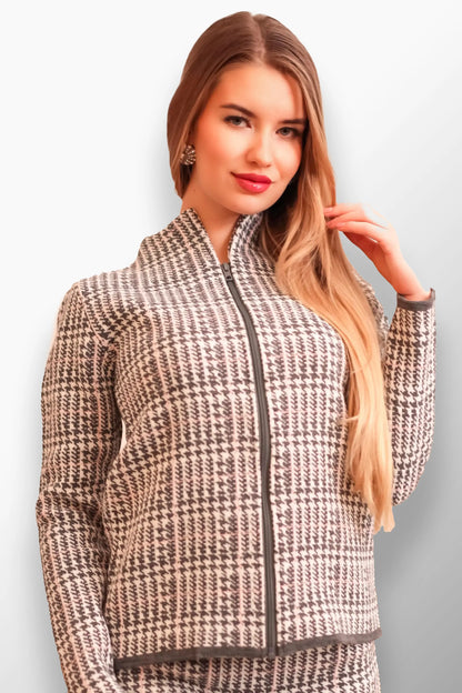 Woman wearing a gray and white plaid short coat with a modern zippered look.