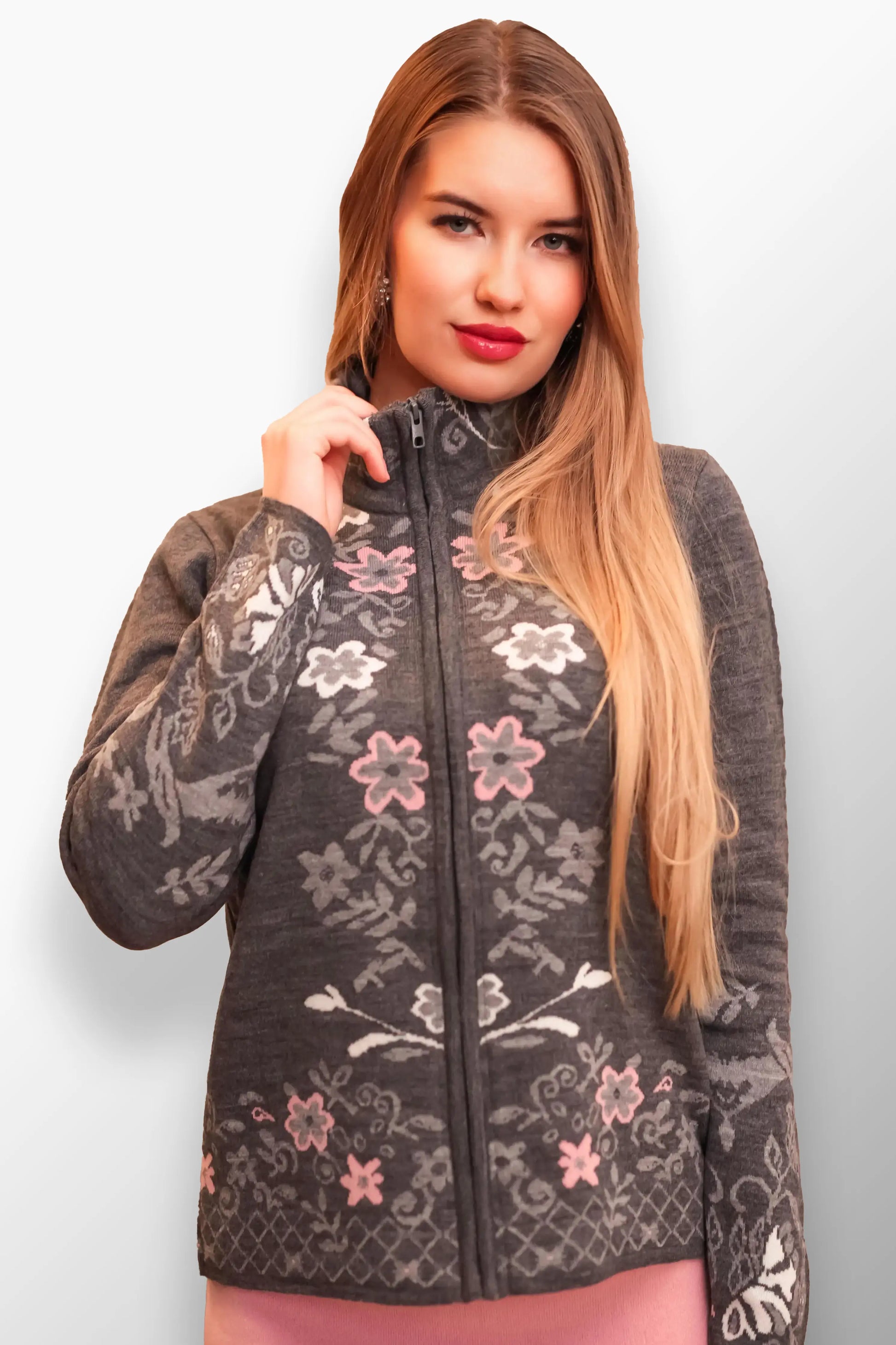 Woman in a floral-accented gray short coat with a high zippered neck.