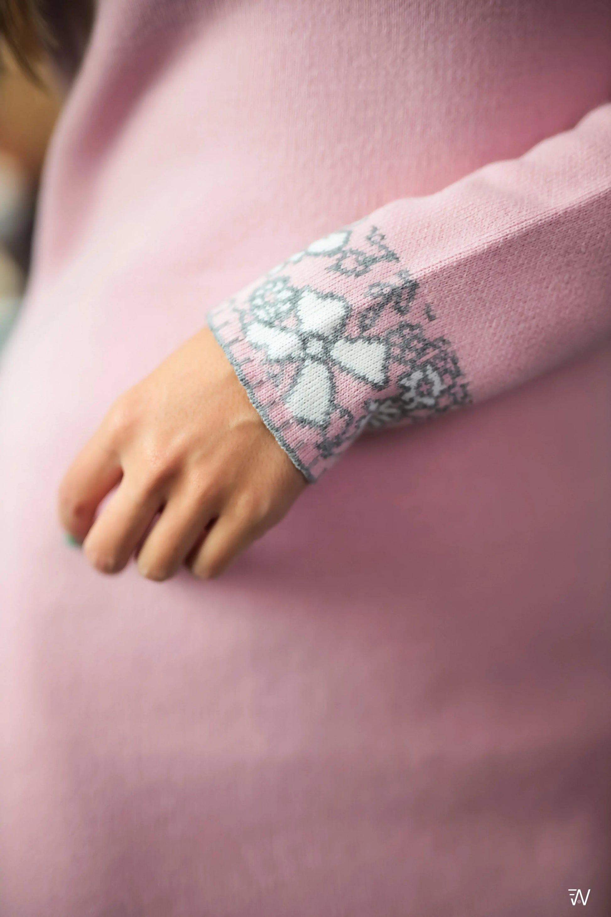 Long-sleeve knit dress with pink and white pattern.