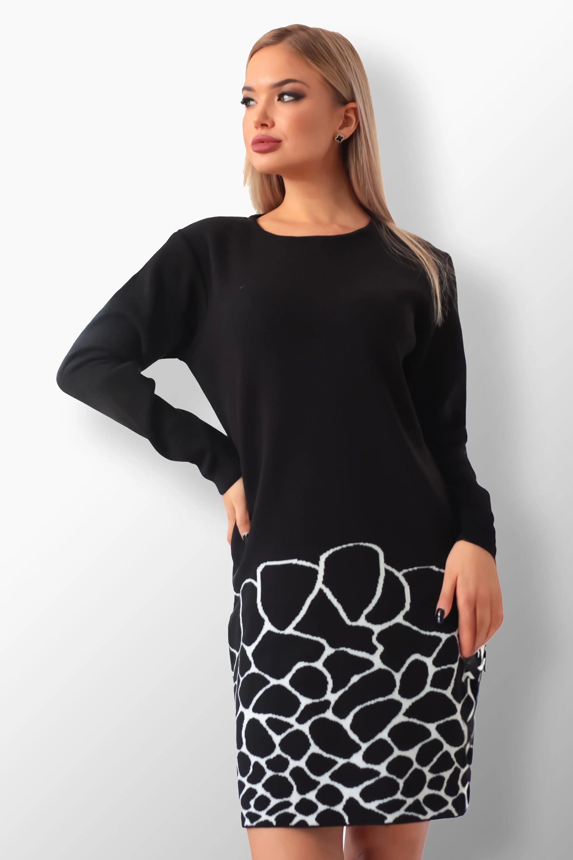 Sara knit dress with black and cream animal print hem.